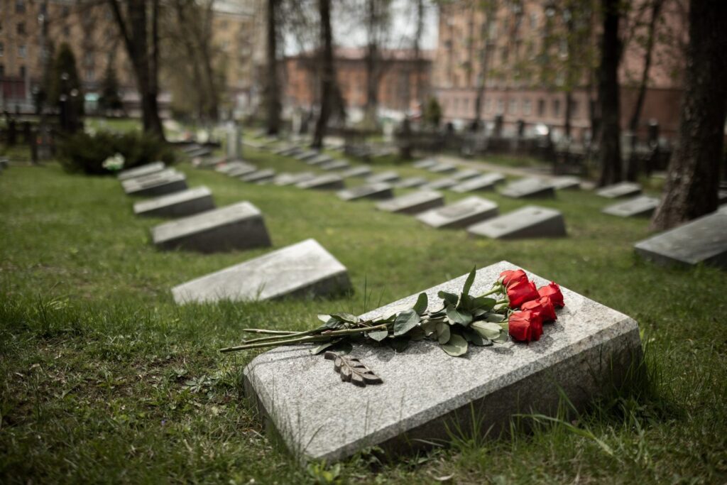 lápide com flores em cemitério
